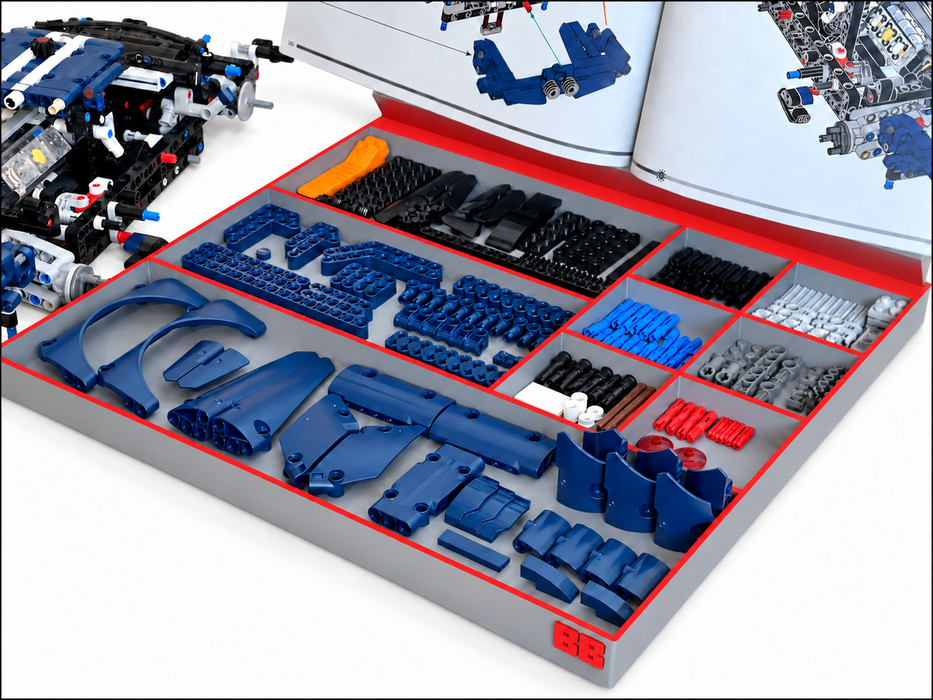 An open storage organizer filled with assorted toy building-block parts in blue, black, gray, and red, with printed instruction pages visible inside the cover and a partially assembled blue and black model visible on the left.